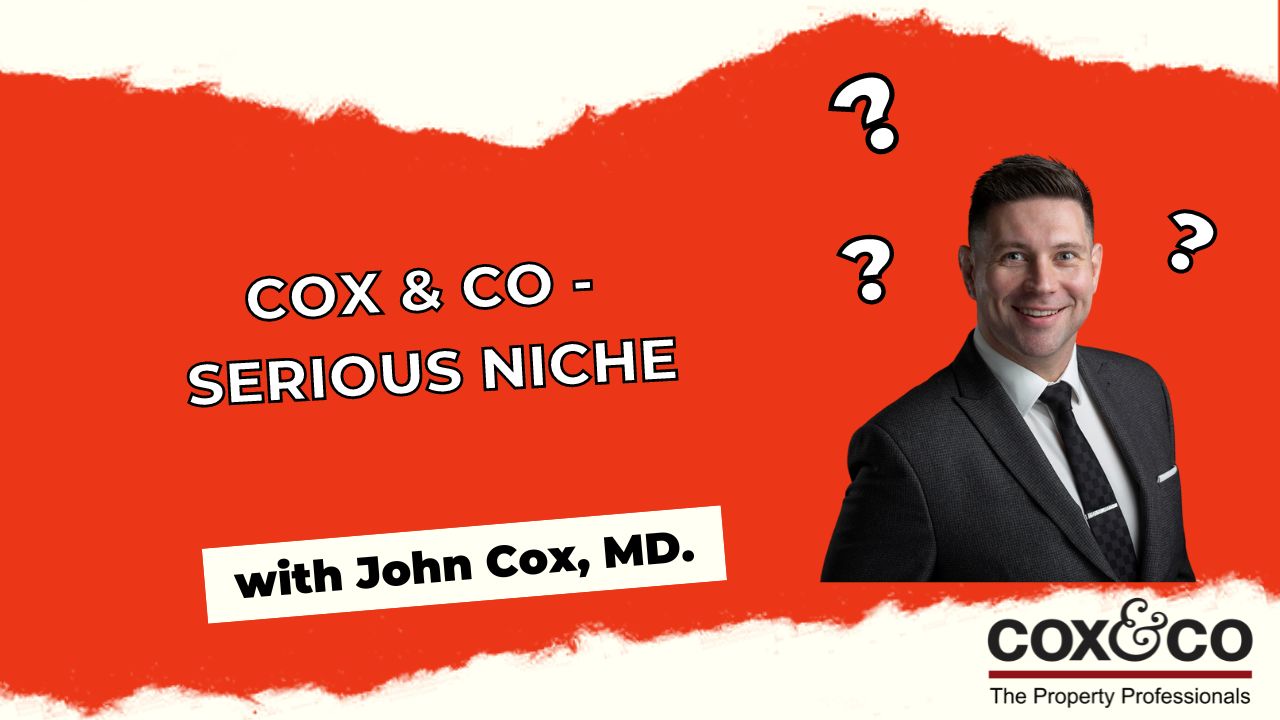 Cox & Co Estate agent in Edinburgh, Scotland. A man wearing a suit and tie stands smiling against a red and white background with question marks around his head. The text reads: "Cox & Co - Serious Niche with John Cox, MD." The Cox & Co logo and tagline "The Property Professionals in Property Sales and Lettings" are at the bottom right.